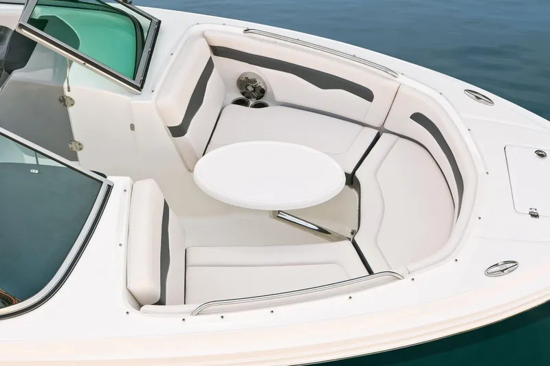 Slide: The Image of Manufacturer Provided Image: 2016 Chaparral 246 SSi boat interior with white seating and round table. - 8