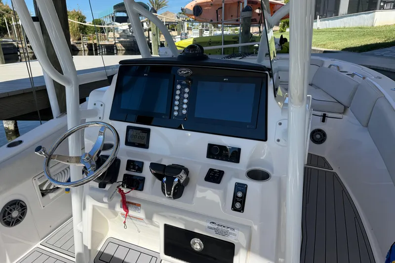 Slide: The Image of 2023 Sea Fox 268 Commander boat dashboard with steering wheel and navigation screens. - 12