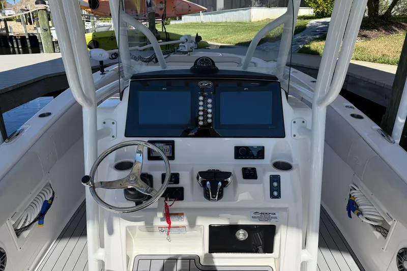 Slide: The Image of 2023 Sea Fox 268 Commander boat dashboard with dual screens and steering wheel. - 13