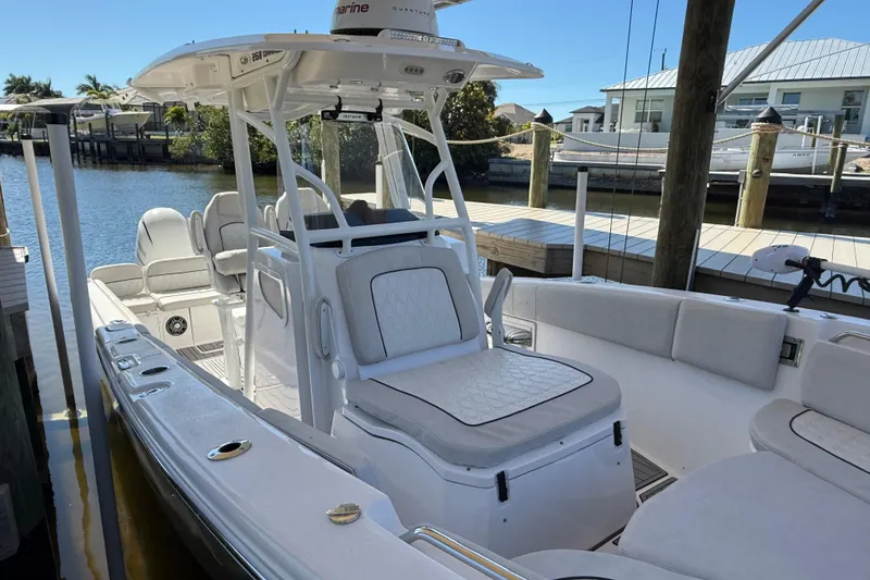 Slide: The Image of 2023 Sea Fox 268 Commander boat docked, featuring sleek white seating and modern design. - 20