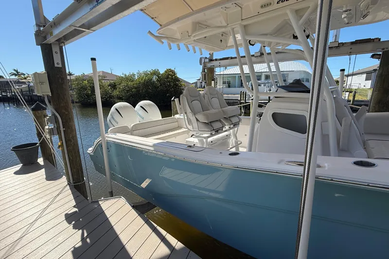 Slide: The Image of 2023 Sea Fox 268 Commander boat docked, featuring sleek design and dual engines. - 4