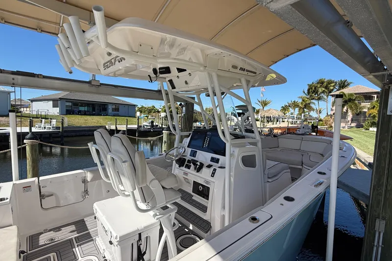 Slide: The Image of 2023 Sea Fox 268 Commander boat docked, featuring modern helm and seating area. - 5