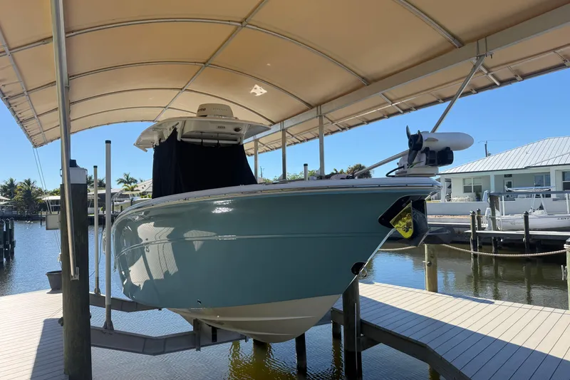 Slide: The Image of 2023 Sea Fox 268 Commander boat docked under canopy on sunny day. - 6