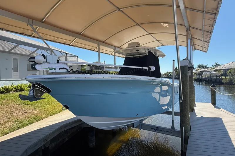 Slide: The Image of 2023 Sea Fox 268 Commander boat docked under a canopy by the water. - 7