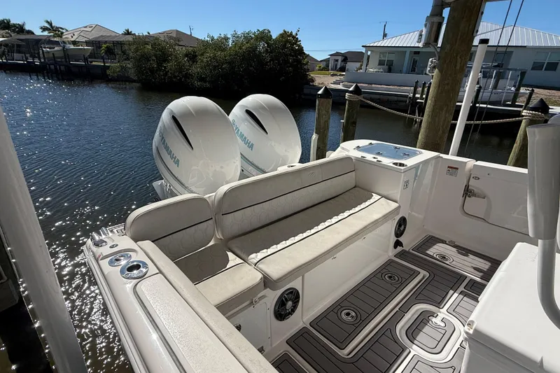 Slide: The Image of 2023 Sea Fox 268 Commander boat with twin Yamaha engines docked by waterfront homes. - 8