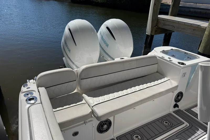 Slide: The Image of 2023 Sea Fox 268 Commander boat with twin Yamaha engines, docked by the water. - 9