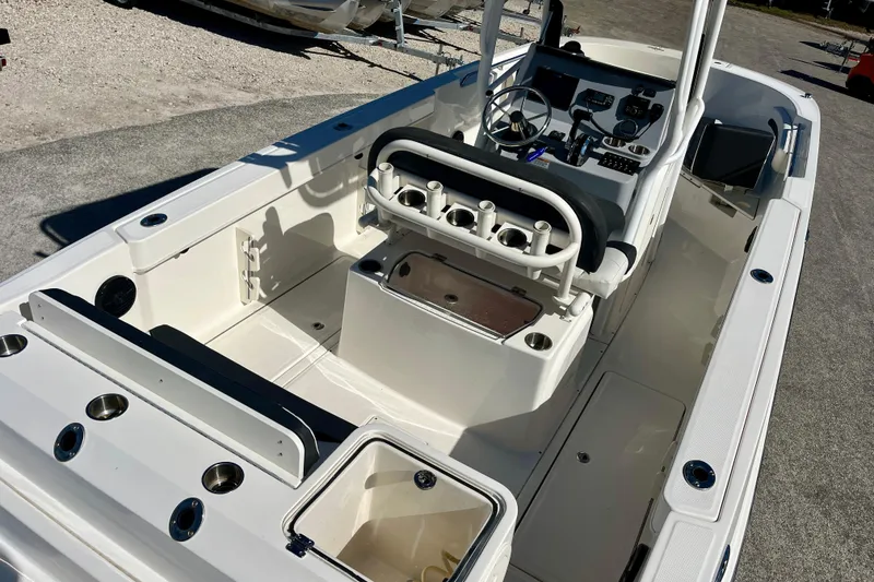 Slide: The Image of 2023 Trophy T24CC boat interior with console, seating, and storage compartments. - 11