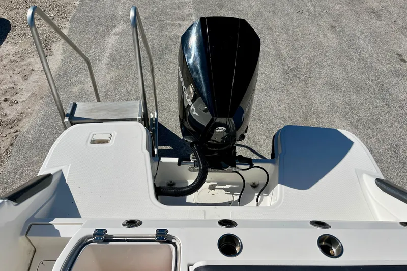 Slide: The Image of 2023 Trophy T24CC boat stern with outboard motor and swim platform. - 15