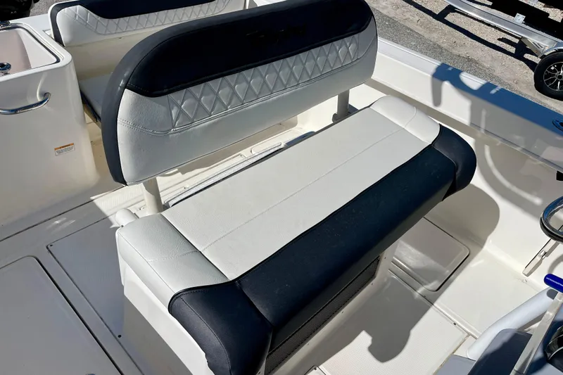 Slide: The Image of 2023 Trophy T24CC boat interior with cushioned seating and storage compartments. - 18