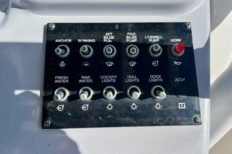 Slide: The Image of Control panel of 2023 Trophy T24CC boat with various switches and labels. - 20