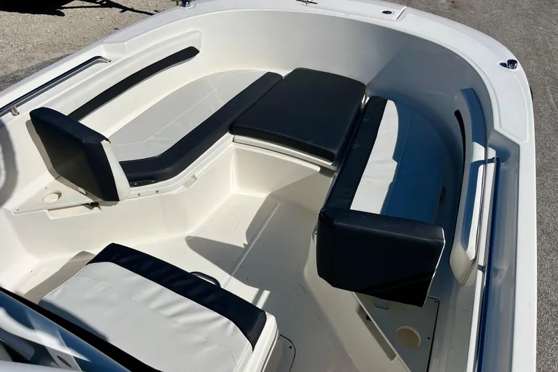 Slide: The Image of 2023 Trophy T24CC boat interior with cushioned seating and sleek design. - 25
