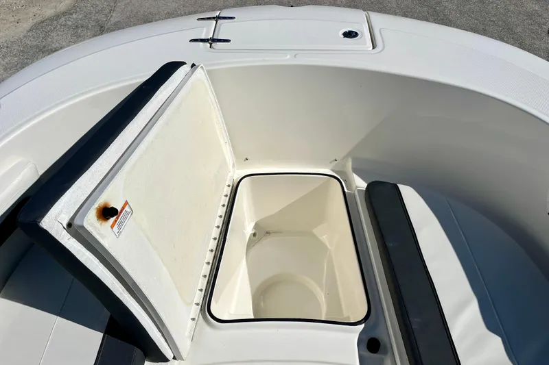 Slide: The Image of 2023 Trophy T24CC boat storage compartment with open lid, showcasing interior space. - 27