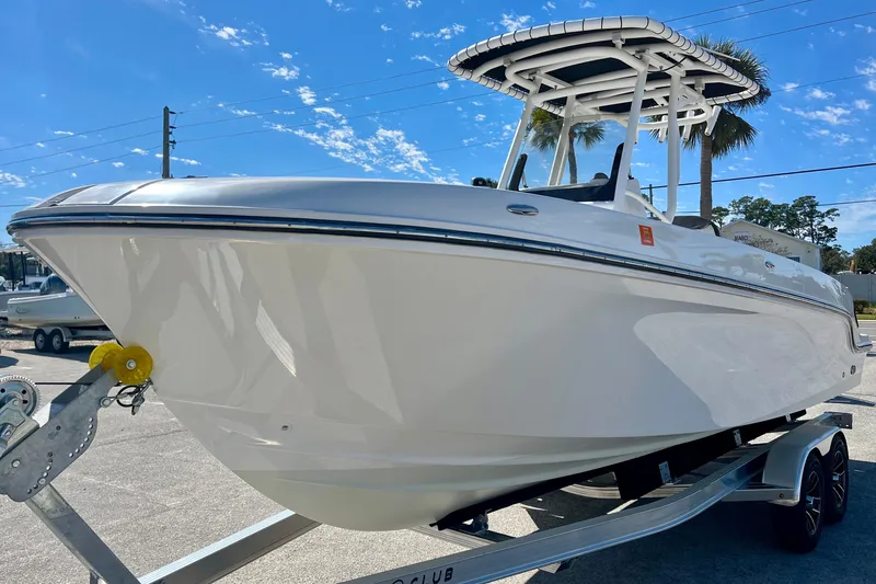 Slide: The Image of 2023 Trophy T24CC boat on trailer under clear blue sky. - 4
