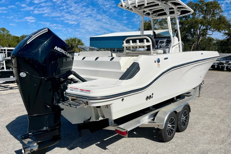 Slide: The Image of 2023 Trophy T24CC boat with Mercury engine on trailer, parked outdoors. - 8