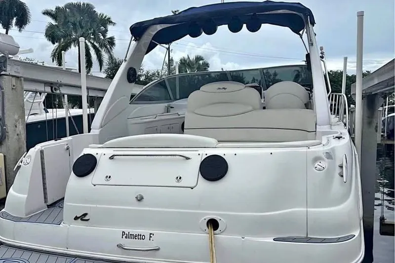 Slide: The Image of 2001 Sea Ray 340 Sundancer yacht docked, featuring sleek design and comfortable seating. - 1