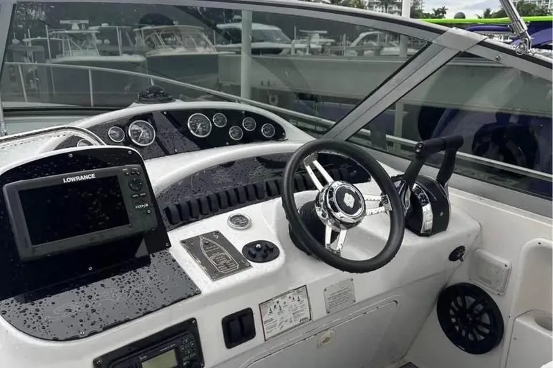 Slide: The Image of 2001 Sea Ray 340 Sundancer helm with steering wheel and navigation equipment. - 4