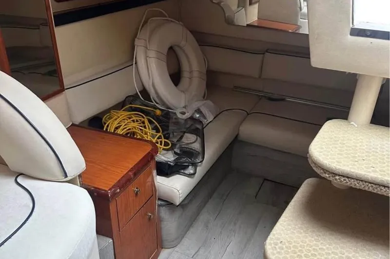 Slide: The Image of Interior of 2001 Sea Ray 340 Sundancer with seating, life preserver, and storage cabinet. - 5