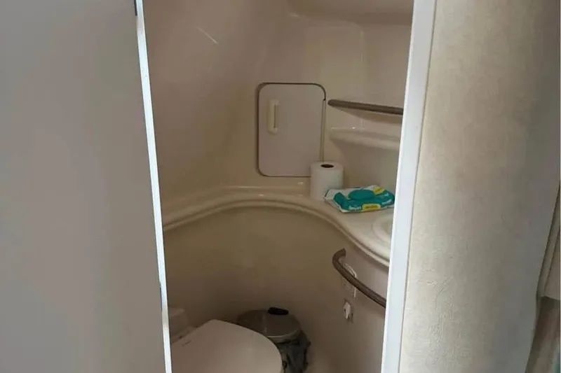 Slide: The Image of Bathroom interior of 2001 Sea Ray 340 Sundancer yacht with toilet and shelves. - 6
