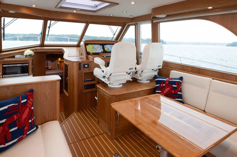 Slide: The Image of Luxurious interior of 2027 Sabre 45 Salon Express yacht with elegant seating and navigation area. - 10