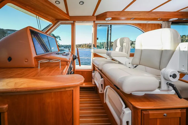 Slide: The Image of Manufacturer Provided Image: 2026 Sabre 45 Salon Express interior with luxurious seating and wooden finishes, overlooking water. - 9