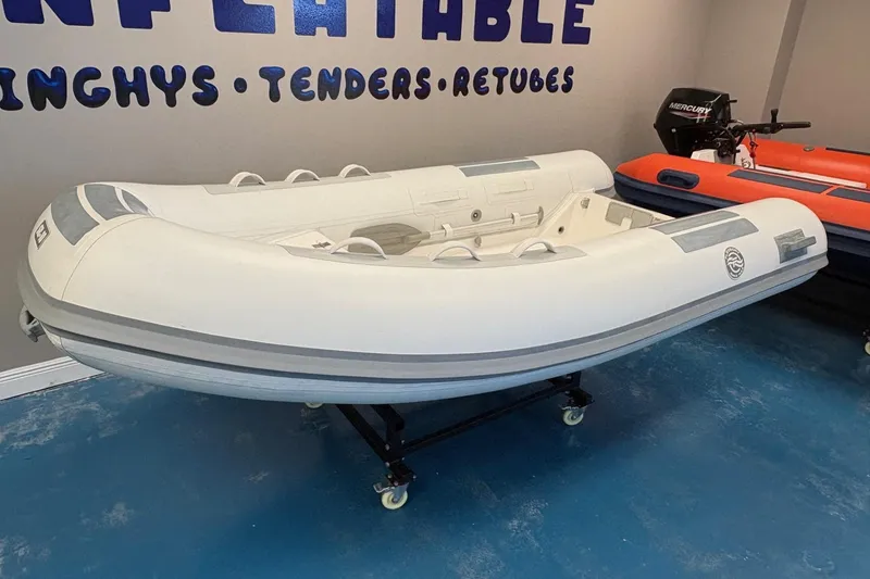 Slide: The Image of 2024 Flexboat SR-10 inflatable boat displayed indoors with promotional signage. - 2