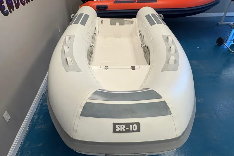 Slide: The Image of 2024 Flexboat SR-10 inflatable boat displayed indoors with promotional signage. - 3