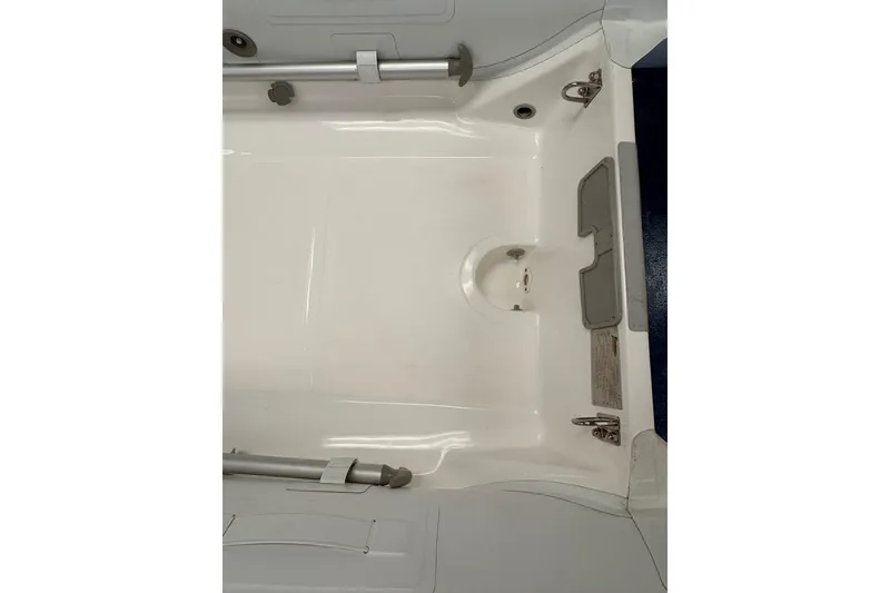 Slide: The Image of 2024 Flexboat SR-10 interior storage compartment, open hatch, white finish. - 6