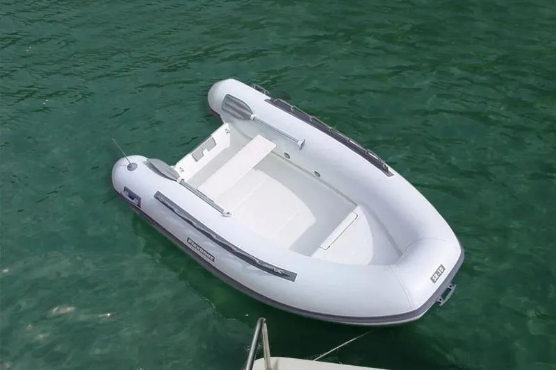 Slide: The Image of 2024 Flexboat SR-10 inflatable boat floating on clear green water. - 7