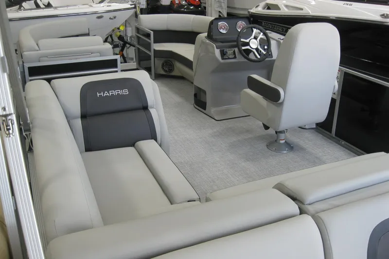 Slide: The Image of 2024 Harris FloteBote Cruiser 210 pontoon boat interior with modern seating and steering console. - 3