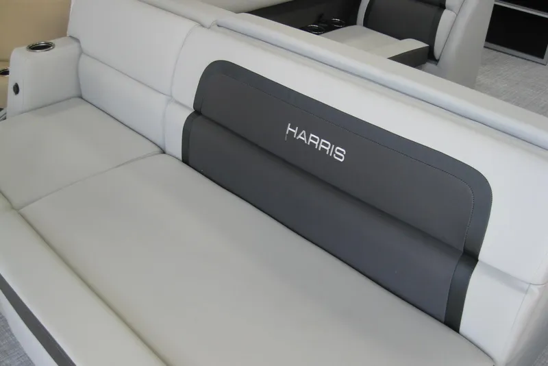 Slide: The Image of 2024 Harris FloteBote Cruiser 210 interior with cushioned seating and stainless steel railings. - 5