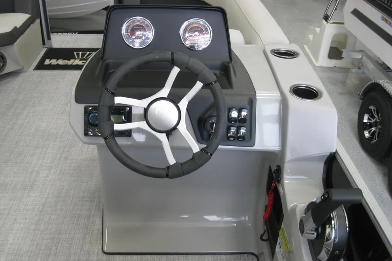 Slide: The Image of 2024 Harris FloteBote Cruiser 210 interior seating with cup holders, gray upholstery. - 7