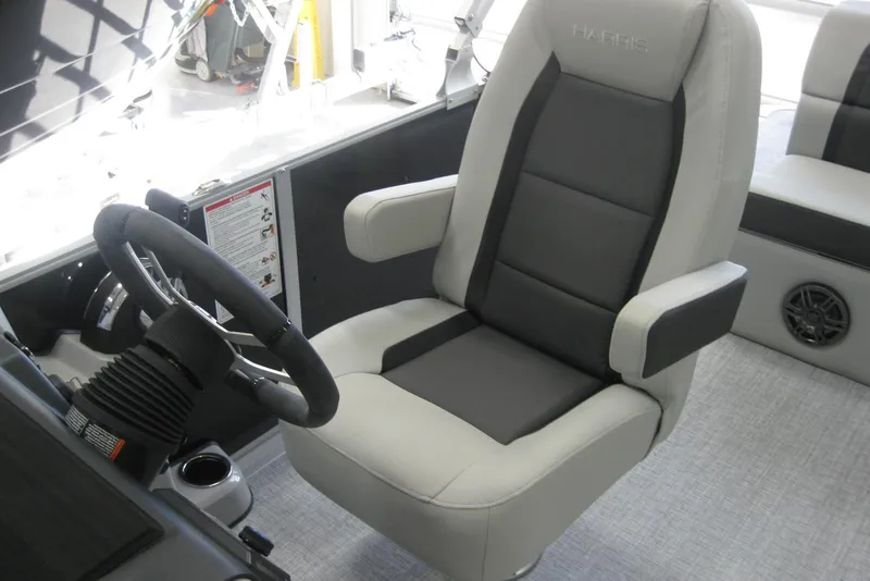 Slide: The Image of 2024 Harris FloteBote Cruiser 210 steering console with modern controls and cup holders. - 8