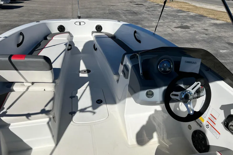 Slide: The Image of 2022 Tahoe T18 boat interior with steering wheel and seating arrangement. - 10