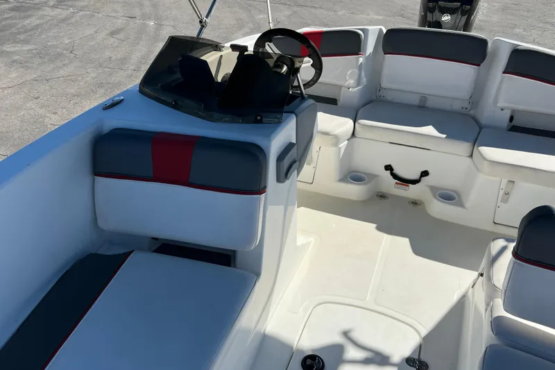 Slide: The Image of 2022 Tahoe T18 boat interior with seating and steering wheel, featuring modern design. - 14