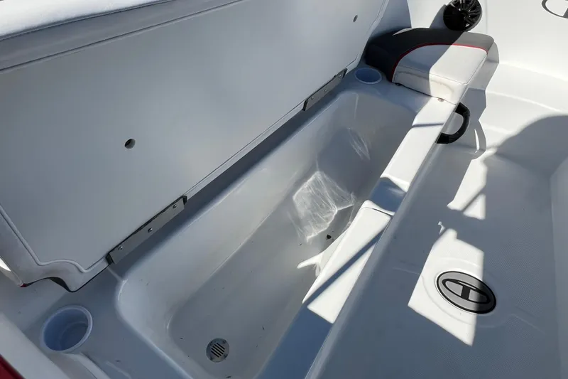 Slide: The Image of 2022 Tahoe T18 boat interior with open storage compartment and seating area. - 17