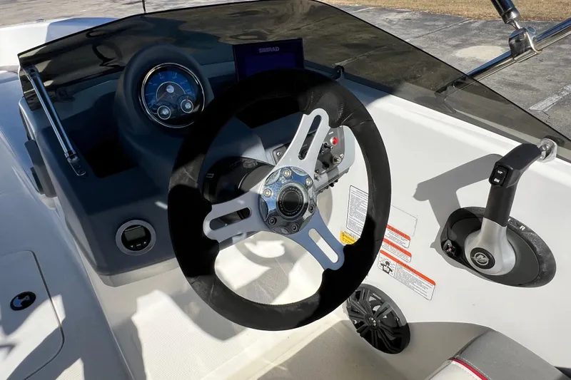 Slide: The Image of 2022 Tahoe T18 boat dashboard with steering wheel and control panel. - 19