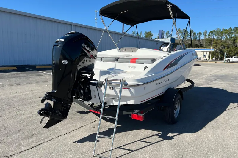 Slide: The Image of 2022 Tahoe T18 boat with Mercury engine on trailer, parked outdoors. - 8