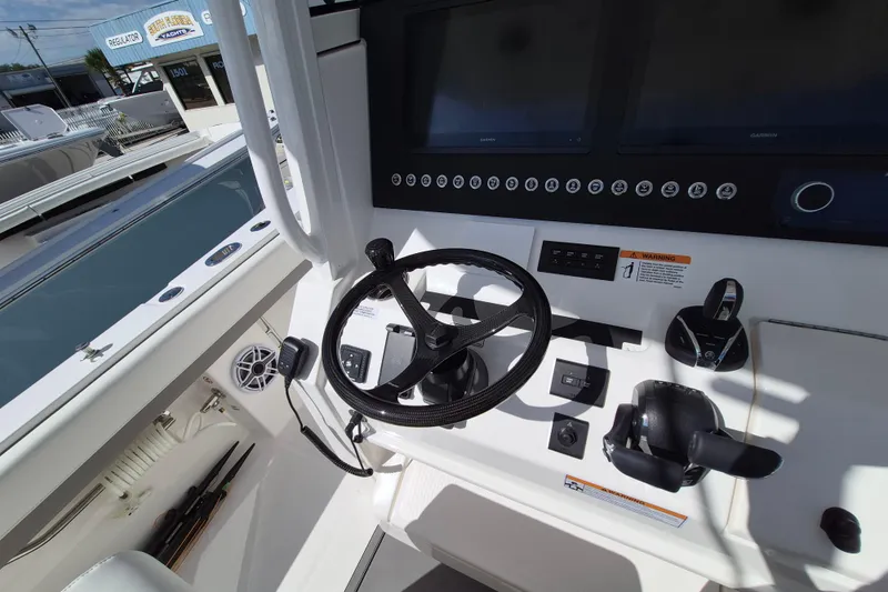 Slide: The Image of 2026 Regulator 31 boat dashboard with steering wheel and control panel. - 12