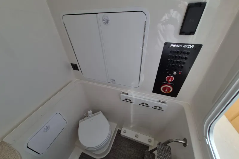 Slide: The Image of 2026 Regulator 31 boat interior with control panel and marine toilet. - 15