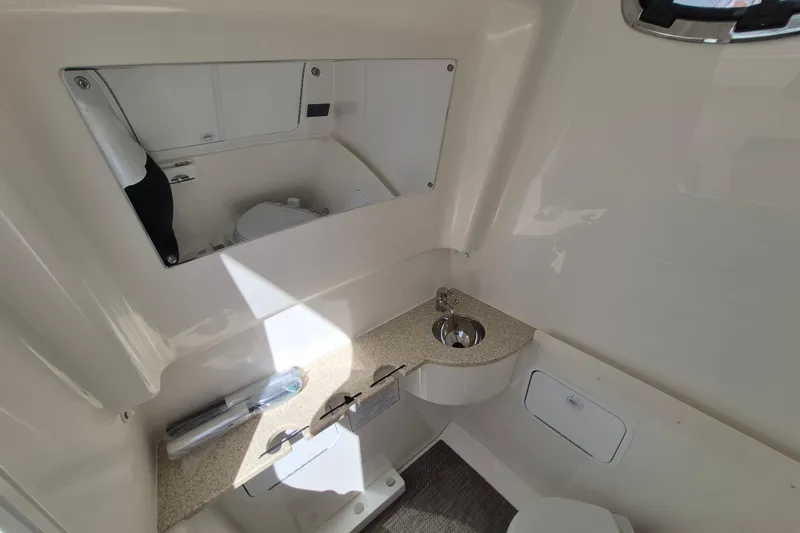 Slide: The Image of 2026 Regulator 31 boat interior with sink, mirror, and storage compartments. - 16