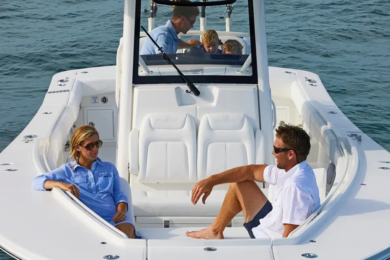 Slide: The Image of 2026 Regulator 31 boat with spacious seating and modern design, docked near palm trees. - 5