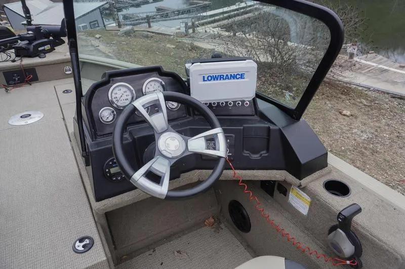 Slide: The Image of 2021 G3 Angler V21 F boat dashboard with steering wheel and Lowrance navigation system. - 11