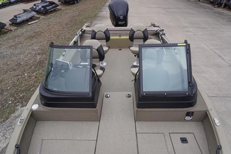 Slide: The Image of 2021 G3 Angler V21 F fishing boat with seating and windshield, docked on concrete. - 12