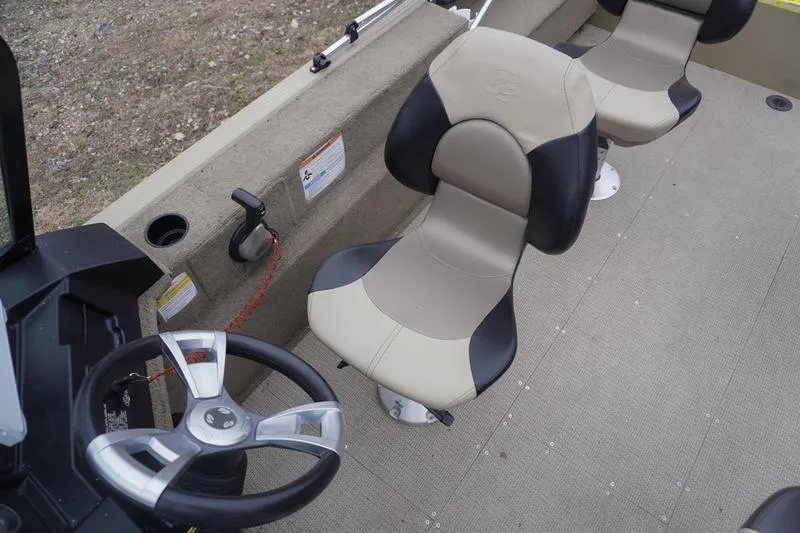 Slide: The Image of 2021 G3 Angler V21 F boat interior with steering wheel and cushioned seats. - 14