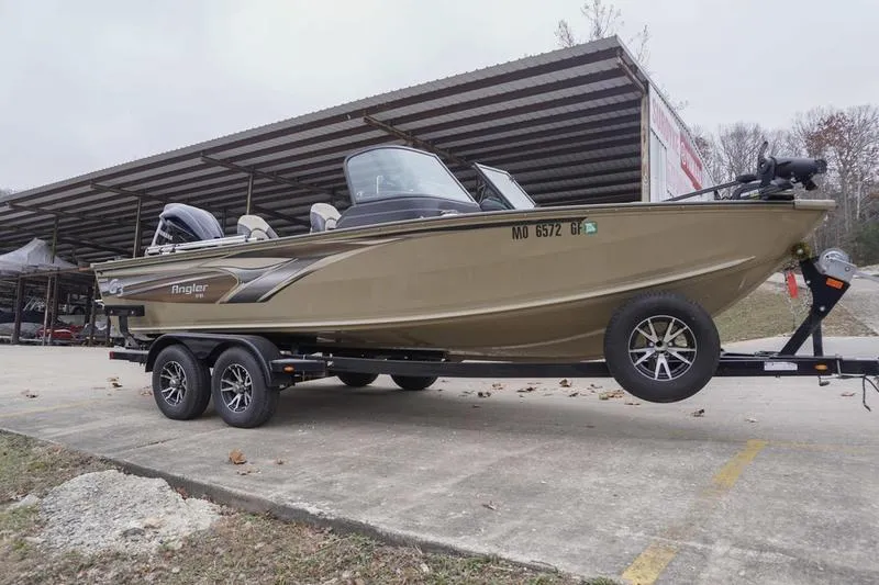 Slide: The Image of 2021 G3 Angler V21 F boat on trailer, parked outdoors. - 2