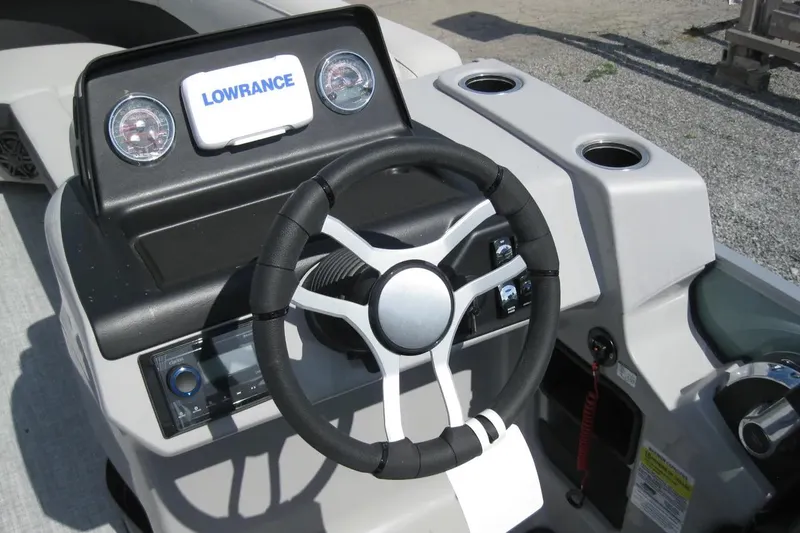 Slide: The Image of 2024 Harris FloteBote Cruiser 230 dashboard with steering wheel and Lowrance display. - 10