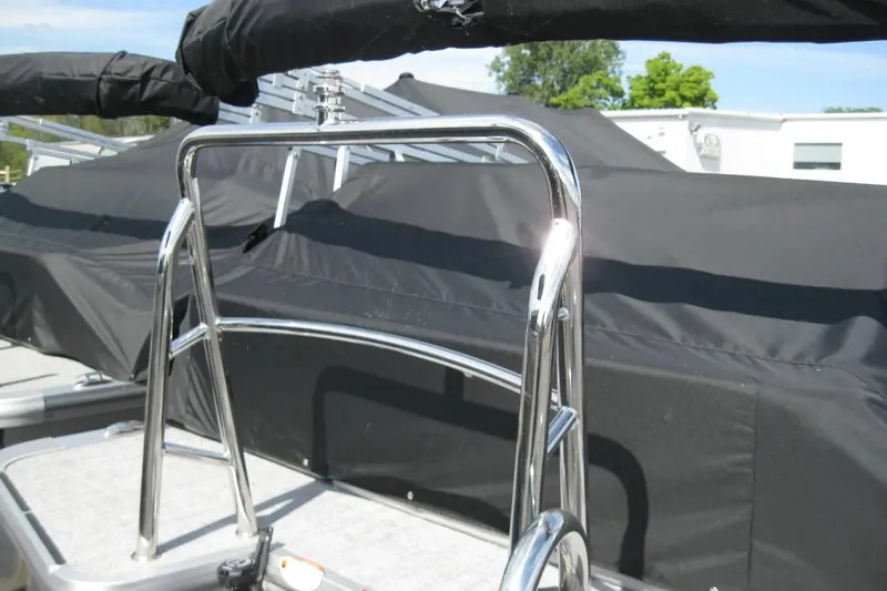 Slide: The Image of 2024 Harris FloteBote Cruiser 230 with chrome railings and black cover. - 5