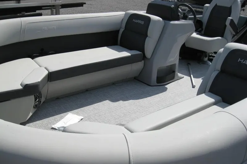 Slide: The Image of 2024 Harris FloteBote Cruiser 230 interior with gray seating and steering console. - 6