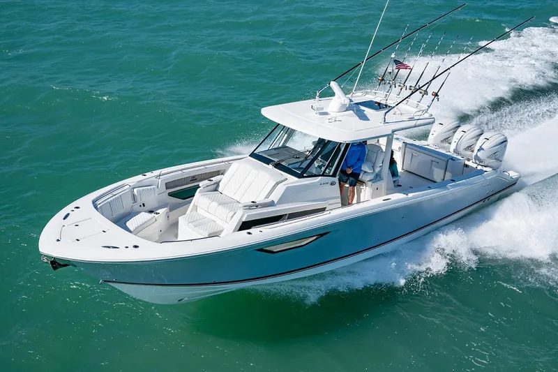 The Image of 2021 Pursuit S 378 Sport boat on turquoise water with city skyline backdrop. - 1