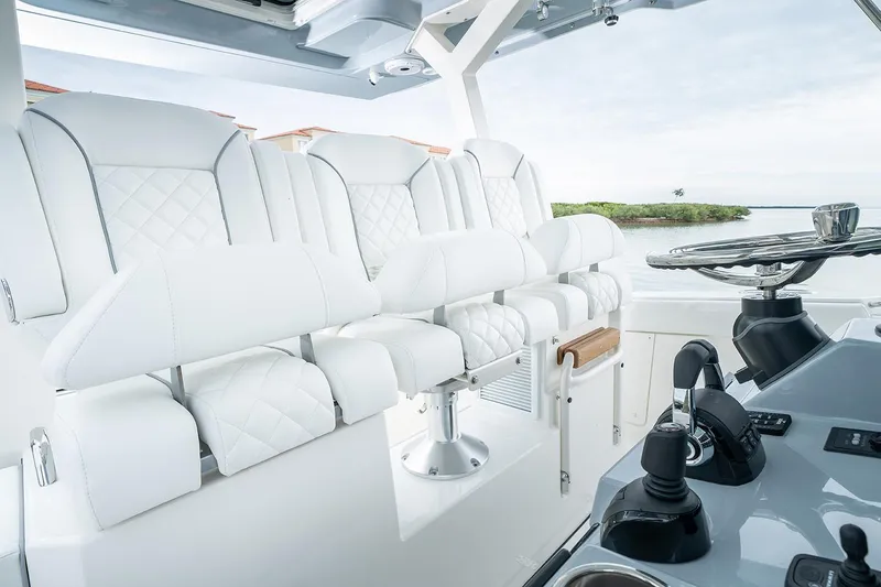 Slide: The Image of 2021 Pursuit S 378 Sport boat on sparkling blue ocean under clear sky. - 11